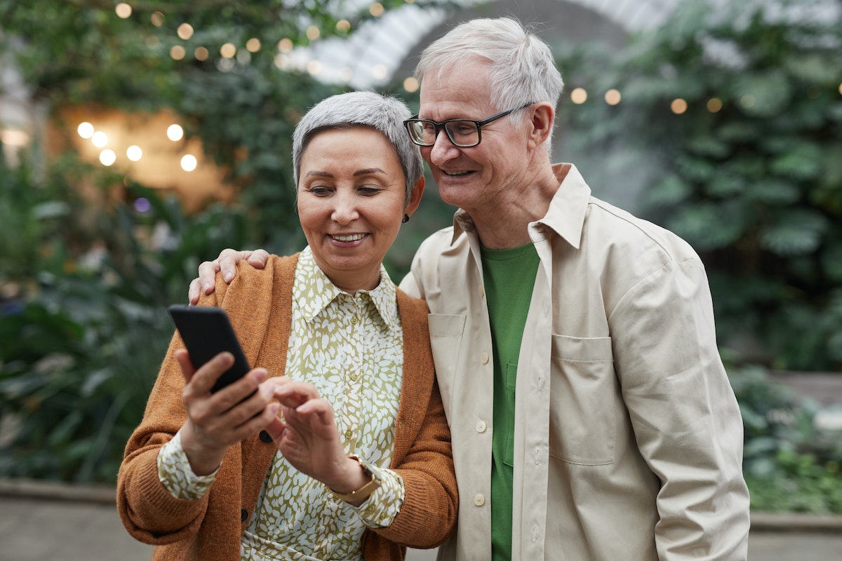 Baby Boomers looking at a phone. 