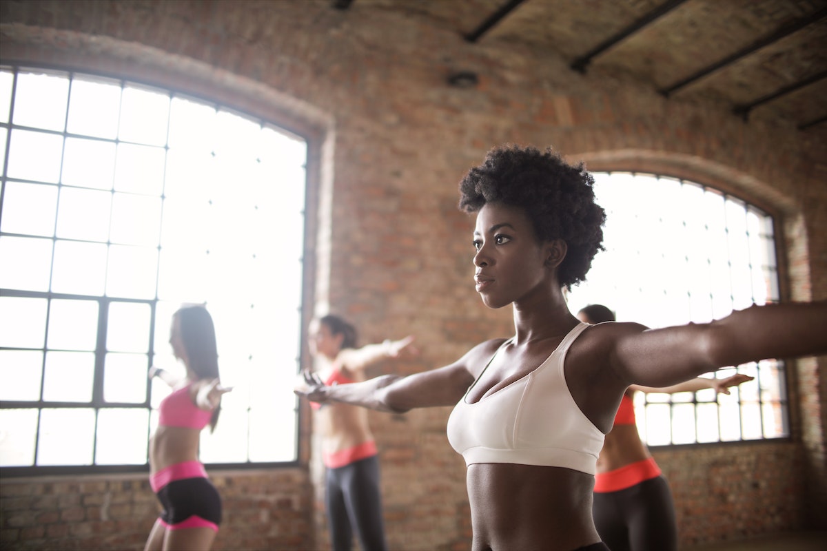 Fitness influencers in a room taking a fitness class.