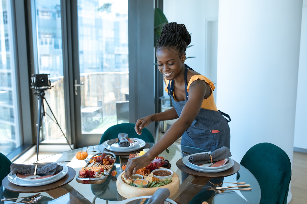 Food nano influencer preparing food and setting a table.