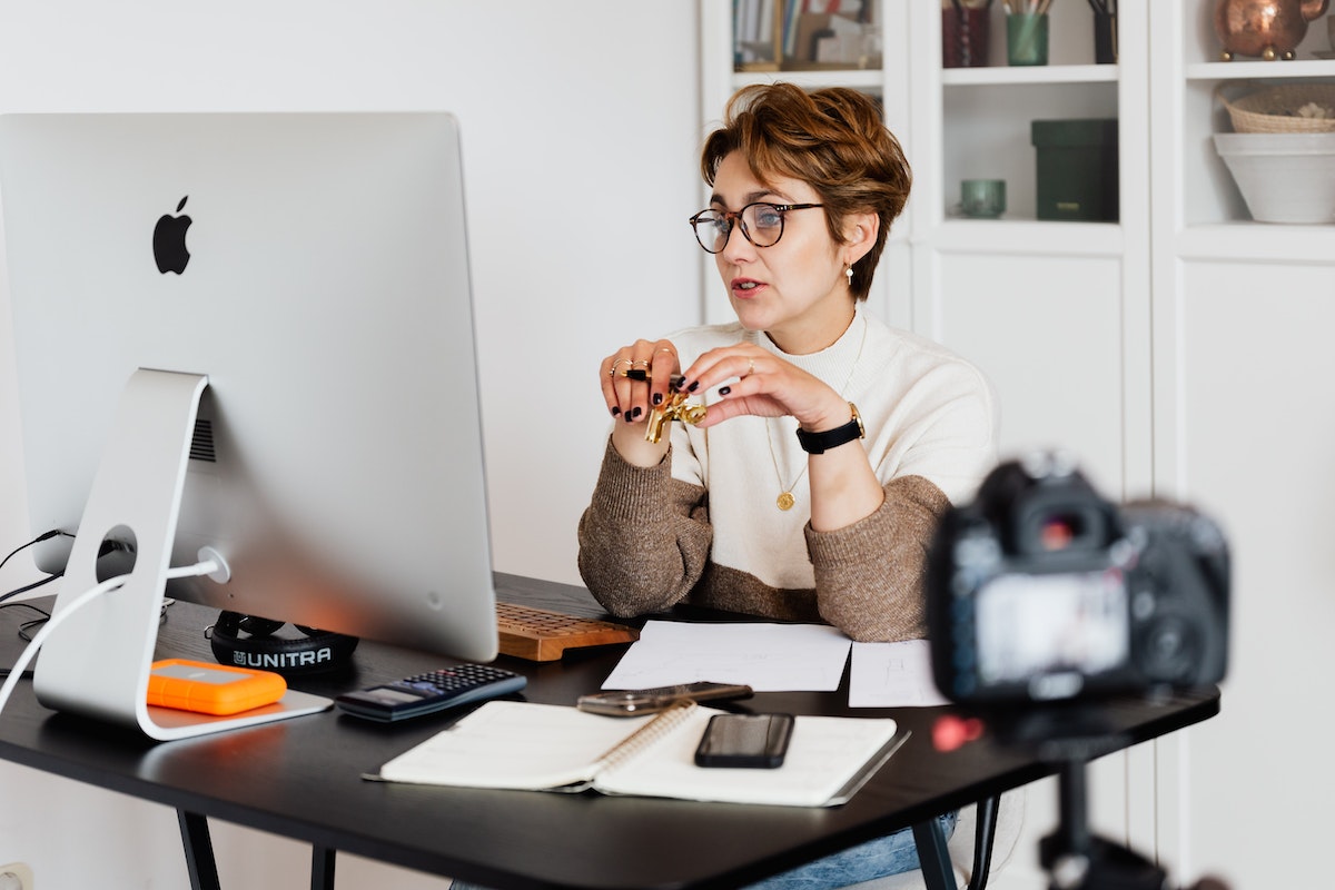 Woman sitting at a desk working at a computer learning about the FTC influencer guidelines updates.