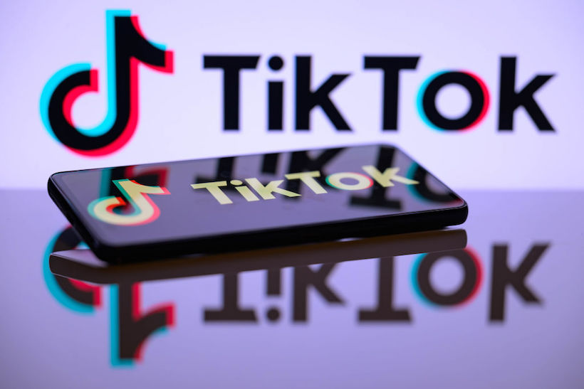 TikTok logo with iPhone