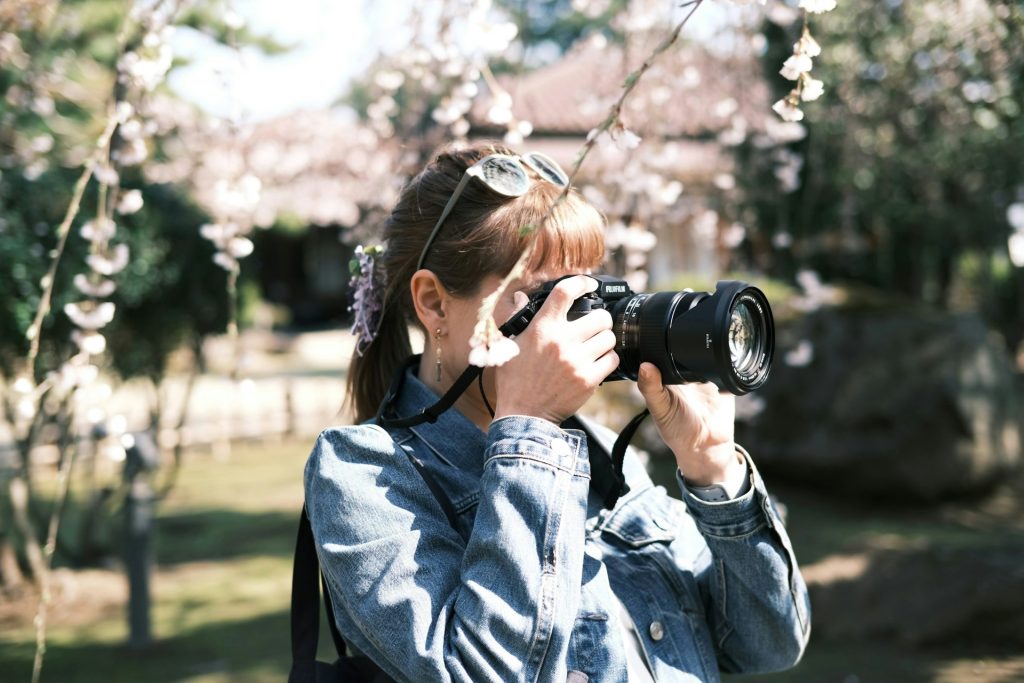 Influencer taking a picture of a cherry tree in the spring.