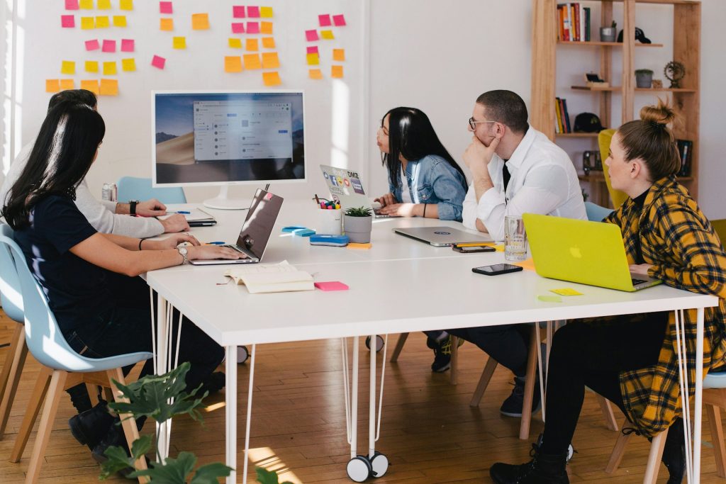 People sitting around a conference table working on a brand marketing strategy.