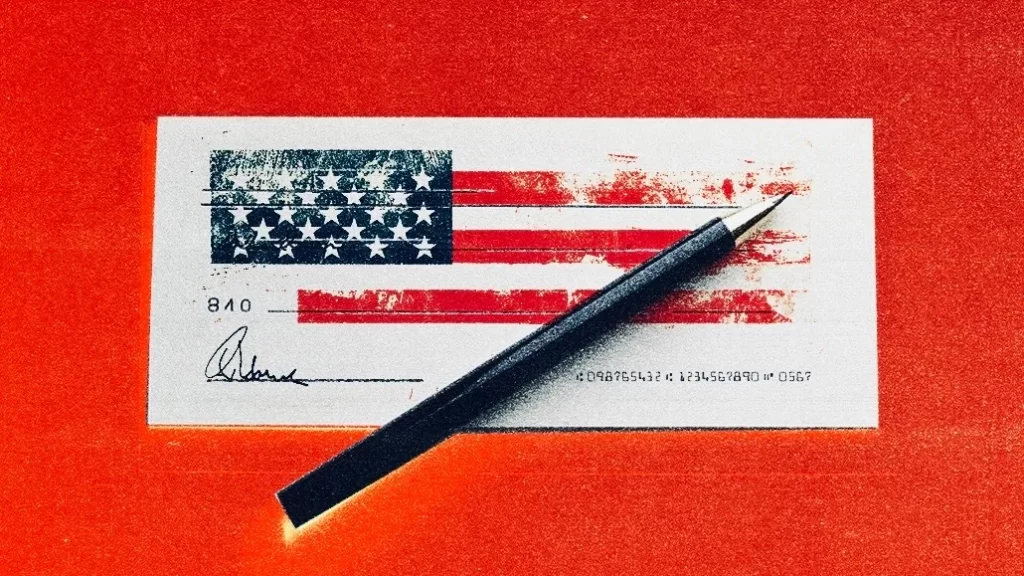 A pen is resting on top of a check with an American flag printed on it. The check is set against a red background.