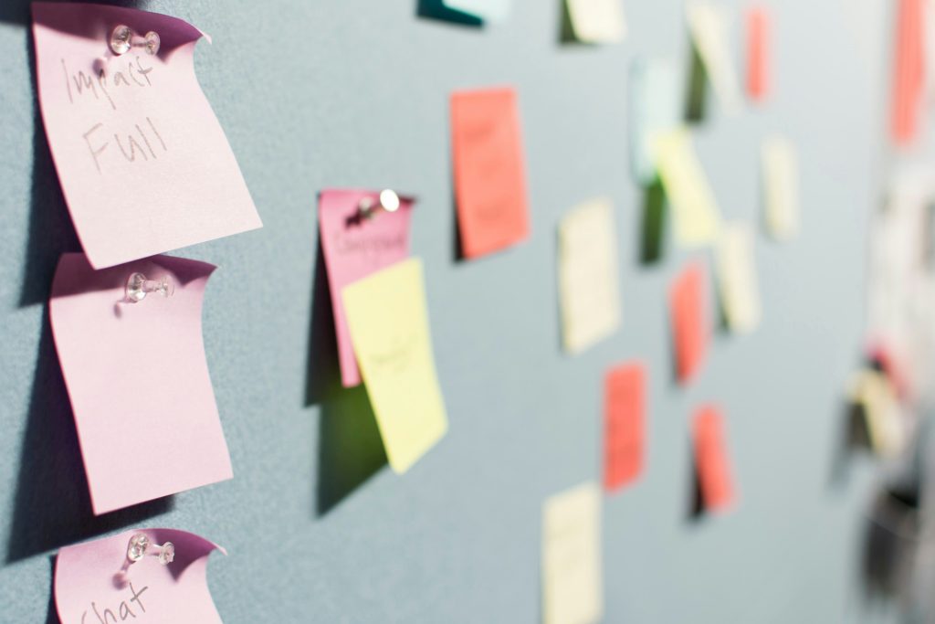 A board with notes attached by push pins to illustrate flexibility in planning an influencer marketing campaign.