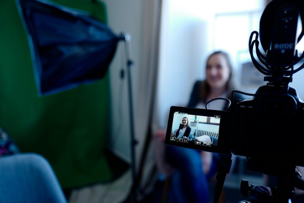 Camera capturing footage of a woman being interviewed for a SMT.